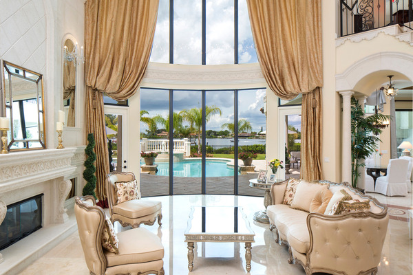 luxurious living room with windows overlooking pool