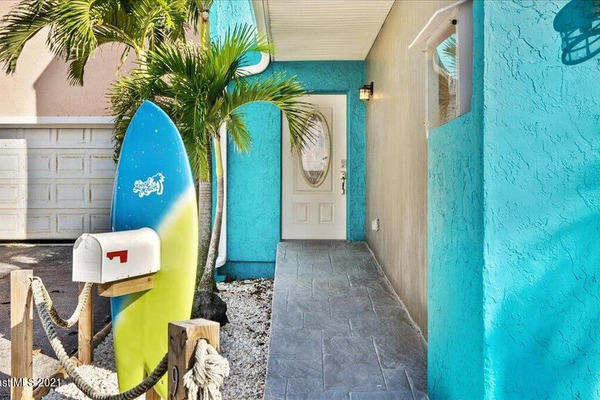 Front door of beach rental house with teal walls