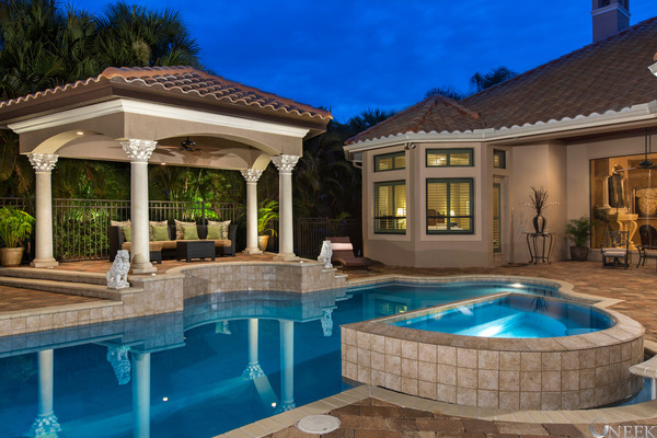 pool and spa beside gazebo at night