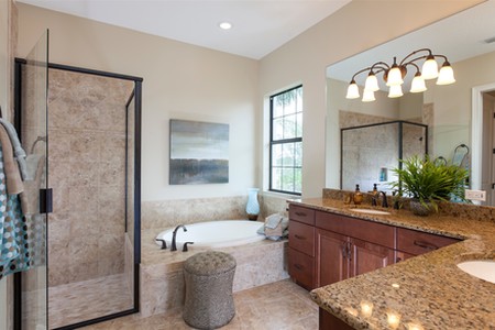 The master suite features double granite topped vanities, glass enclosed shower and soaking tub.